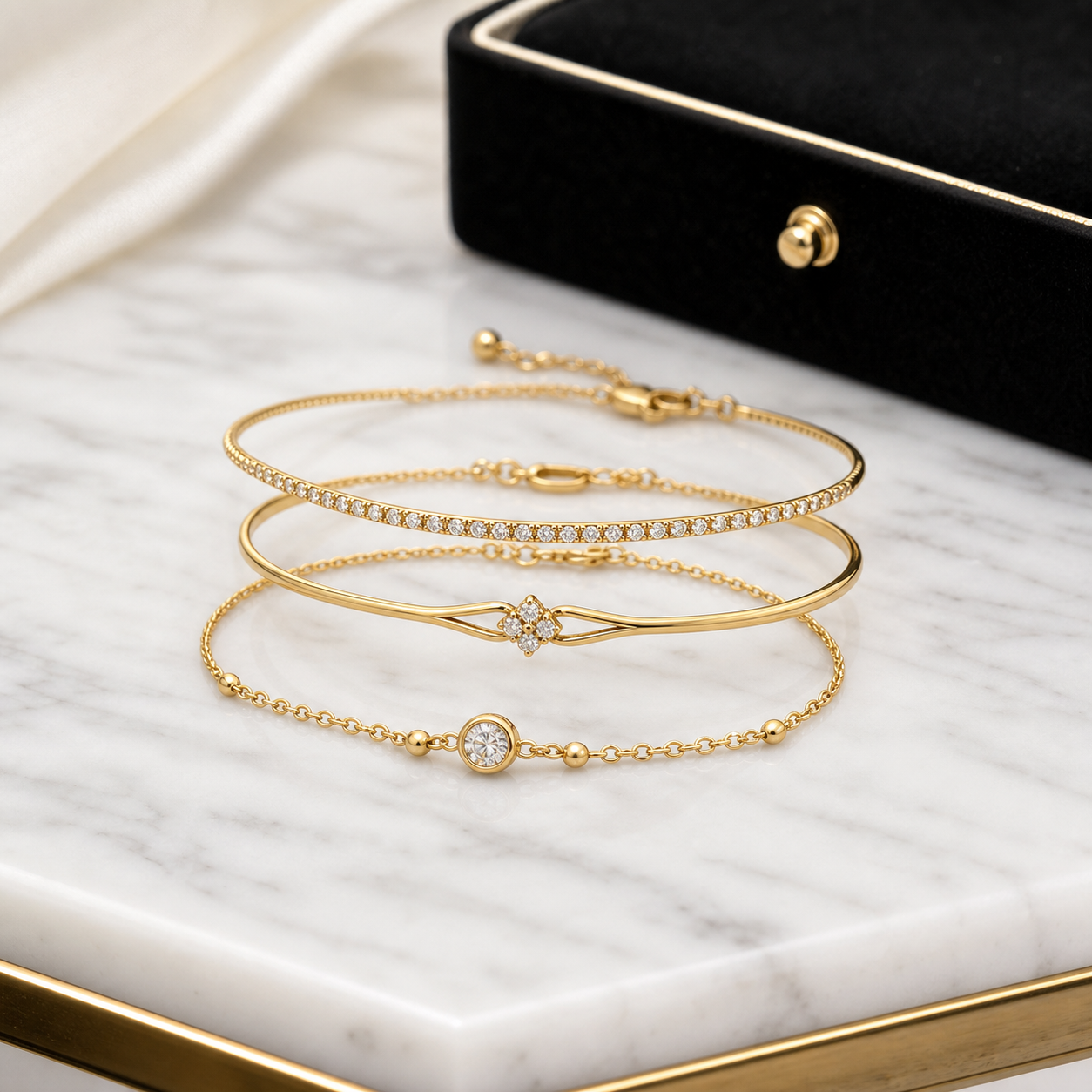 Gold bracelet stack on marble